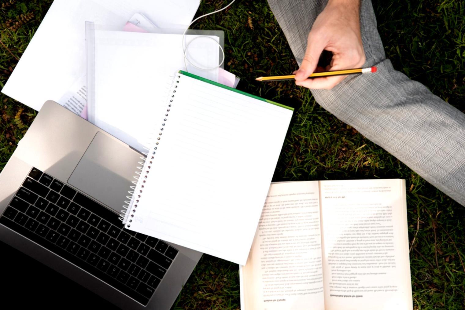 Student analyzing financial charts and trading data on multiple screens